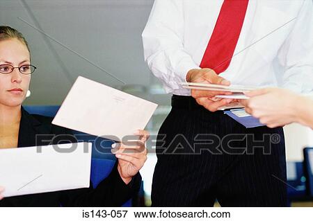 Stock Photo - Colleagues dealing with post. Fotosearch