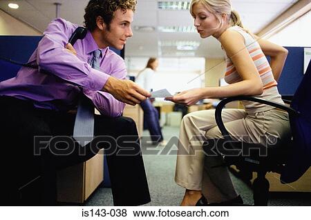 Colleagues discuss paperwork View Large Photo Image Stock Photo - Colleagues discuss paperwork. Fotosearch