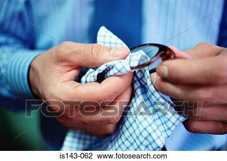 Man cleaning spectacle lenses View Large Photo Image Stock Image - Man cleaning spectacle lenses. Fotosearch