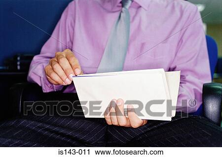 Stock Image - Man looking through mail. Fotosearch