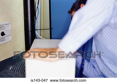 Stock Photo - Man with computer and leads. Fotosearch