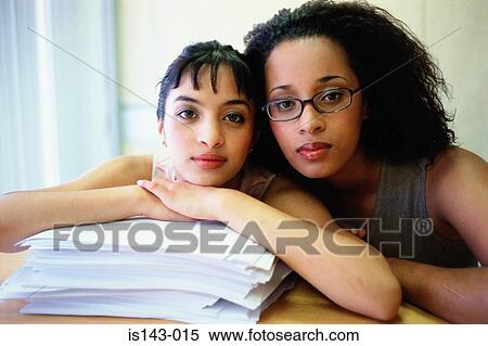 Stock Photography - Two women and stack of paper. Fotosearch