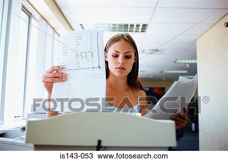 Woman about to shred paper View Large Photo Image Stock Image - Woman about to shred paper. Fotosearch
