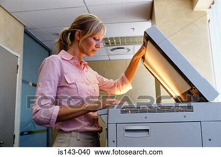Stock Image - Woman uses the photocopier. Fotosearch
