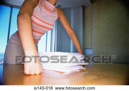 Stock Photo - Woman with stack of papers. Fotosearch