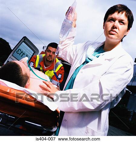 Ambulance staff with patient View Large Photo Image Stock Photo - Ambulance staff with patient. Fotosearch