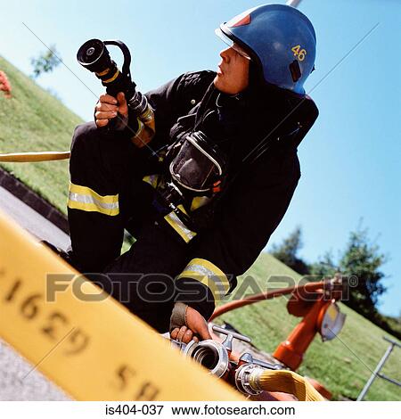 Fireman connecting hoses View Large Photo Image Stock Photo - Fireman connecting hoses. Fotosearch