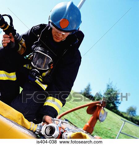 Fireman connecting hoses View Large Photo Image Stock Photo - Fireman connecting hoses. Fotosearch
