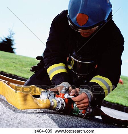 Fireman connecting hoses View Large Photo Image Stock Photo - Fireman connecting hoses. Fotosearch