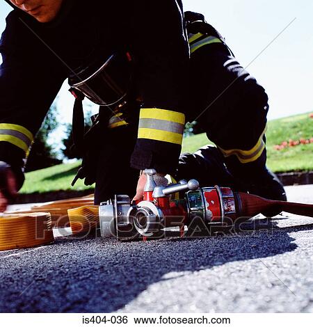 Fireman connecting hoses View Large Photo Image Stock Photograph - Fireman connecting hoses. Fotosearch