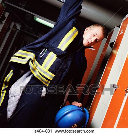 Stock Image - Fireman getting ready to leave. Fotosearch
