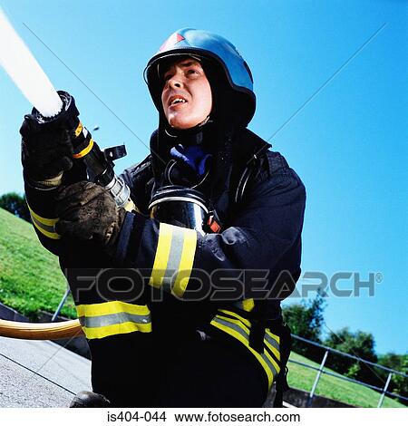 Fireman operating hose View Large Photo Image Picture - Fireman operating hose. Fotosearch