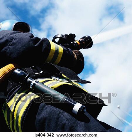 Fireman operating hose View Large Photo Image Stock Image - Fireman operating hose. Fotosearch