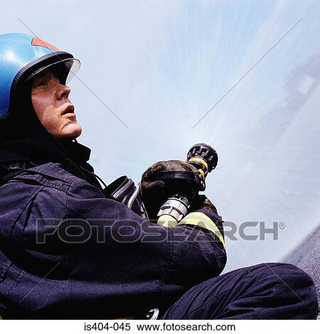 Fireman operating hose View Large Photo Image Stock Photography - Fireman operating hose. Fotosearch