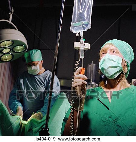 Stock Photo - Nurse monitoring fluids. Fotosearch