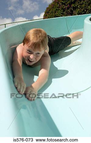 Stock Image - Boy enjoying waterslide. Fotosearch