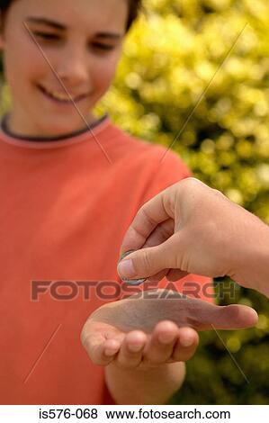Boy receiving coin in hand View Large Photo Image Stock Photo - Boy receiving coin in hand. Fotosearch