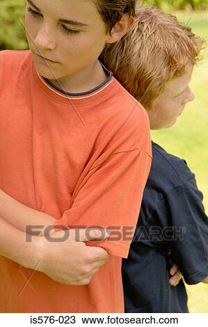 Boys not talking to eachother View Large Photo Image Stock Image - Boys not talking to eachother. Fotosearch