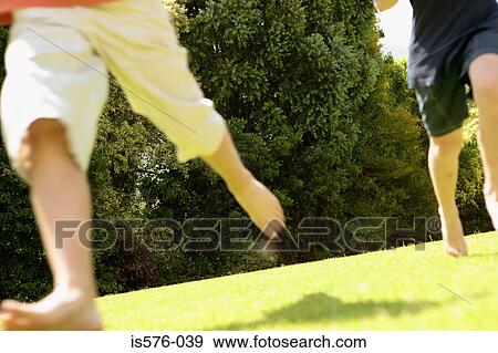 Boys running on the grass View Large Photo Image Stock Photo - Boys running on the grass. Fotosearch