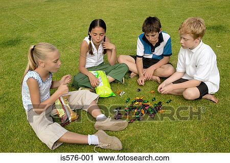 Stock Image - Children eating sweets. Fotosearch