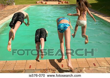 Stock Image - Children jumping into pool. Fotosearch