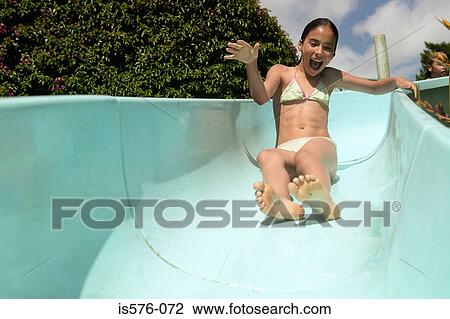 Stock Image - Girl enjoying waterslide. Fotosearch
