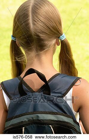 Stock Photo - Girl with rucksack on her back. Fotosearch
