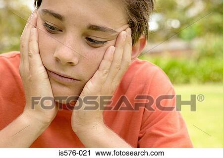 Stock Image - Serious young boy outdoors. Fotosearch