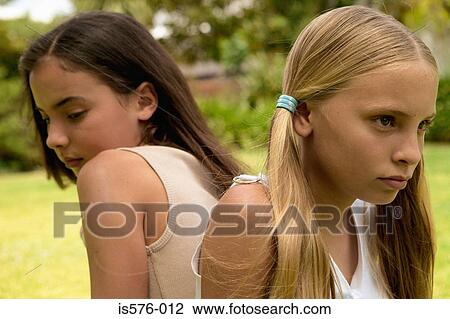 Two girlfriends not talking View Large Photo Image Stock Image - Two girlfriends not talking. Fotosearch
