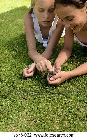 Two girls with mobile phone View Large Photo Image Stock Image - Two girls with mobile phone. Fotosearch