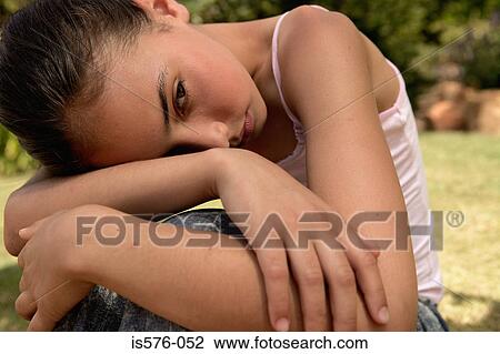 Stock Image - Unhappy young girl outdoors. Fotosearch
