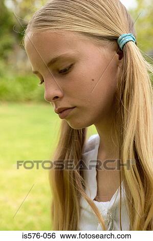 Unhappy young girl outdoors View Large Photo Image Stock Photograph - Unhappy young girl outdoors. Fotosearch