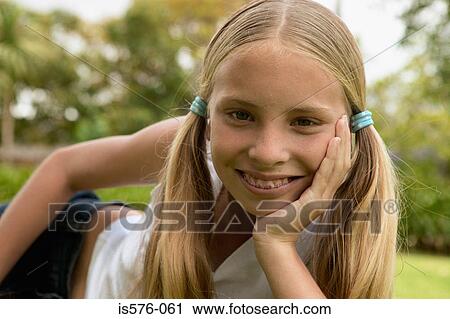 Stock Image - Young girl smiling at camera. Fotosearch