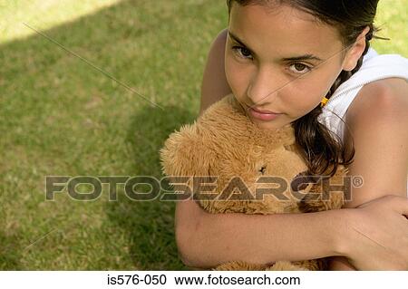 Stock Image - Young girl with teddy bear. Fotosearch