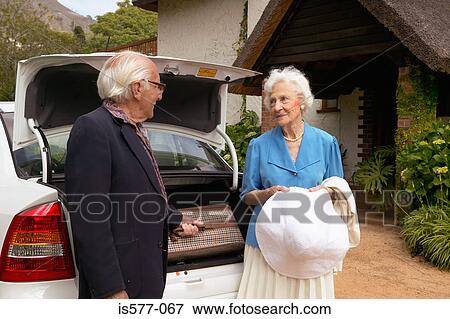 Stock Photo - Older couple arrive by car. Fotosearch