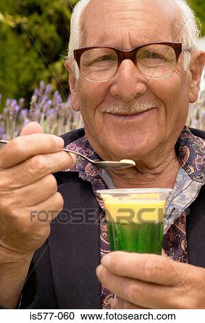 Stock Image - Older man enjoying dessert. Fotosearch