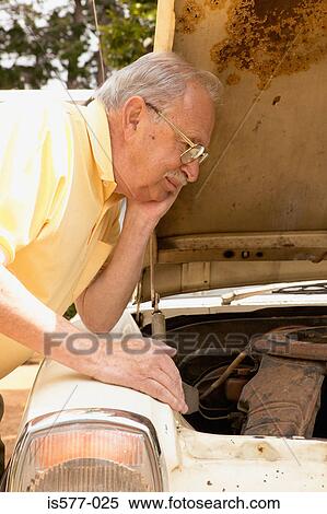 Older man looks at car engine View Large Photo Image Stock Photography - Older man looks at car engine. Fotosearch