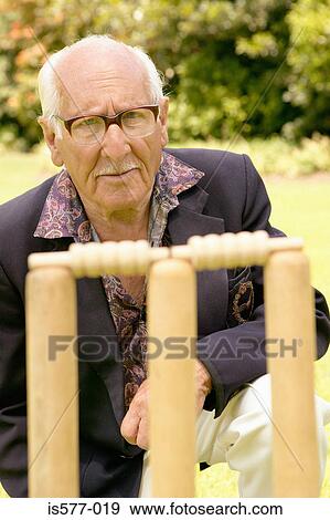 Older man with cricket stumps View Large Photo Image Stock Photo - Older man with cricket stumps. Fotosearch