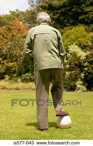 Stock Image - Older man with football . Fotosearch