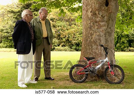 Older men in garden & bicycle View Large Photo Image Stock Photo - Older men in garden & bicycle. Fotosearch