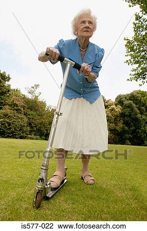 Older woman in the garden View Large Photo Image Stock Image - Older woman in the garden. Fotosearch