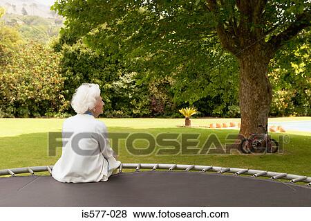 Stock Photo - Older woman in the garden. Fotosearch