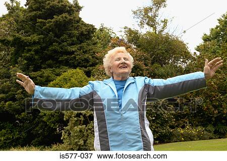 Older woman stretches outside View Large Photo Image Stock Photo - Older woman stretches outside. Fotosearch