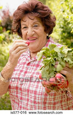 Older woman with radishes View Large Photo Image Stock Photograph - Older woman with radishes. Fotosearch
