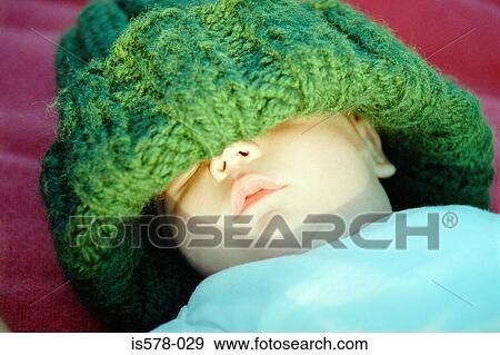 Baby in oversize woolie hat View Large Photo Image Stock Photo - Baby in oversize woolie hat. Fotosearch