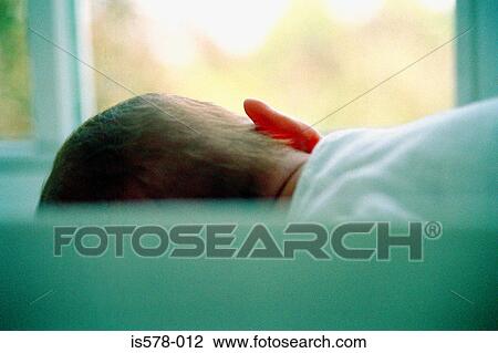 Stock Image - Baby lying down. Fotosearch