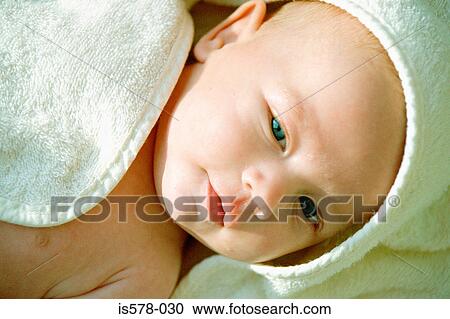 Stock Image - Baby wrapped up in a bath towel. Fotosearch