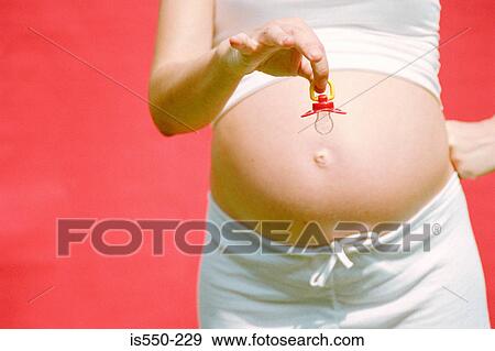 Mother-to-be holding a dummy View Large Photo Image Stock Photo - Mother-to-be holding a dummy. Fotosearch