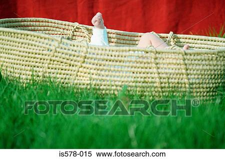 Straw baby carrier on grass View Large Photo Image Stock Photography - Straw baby carrier on grass. Fotosearch