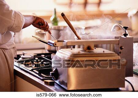 Stock Photograph - Chef at work in the kitchen. Fotosearch
